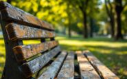 Community members gather around a vandalized memorial bench